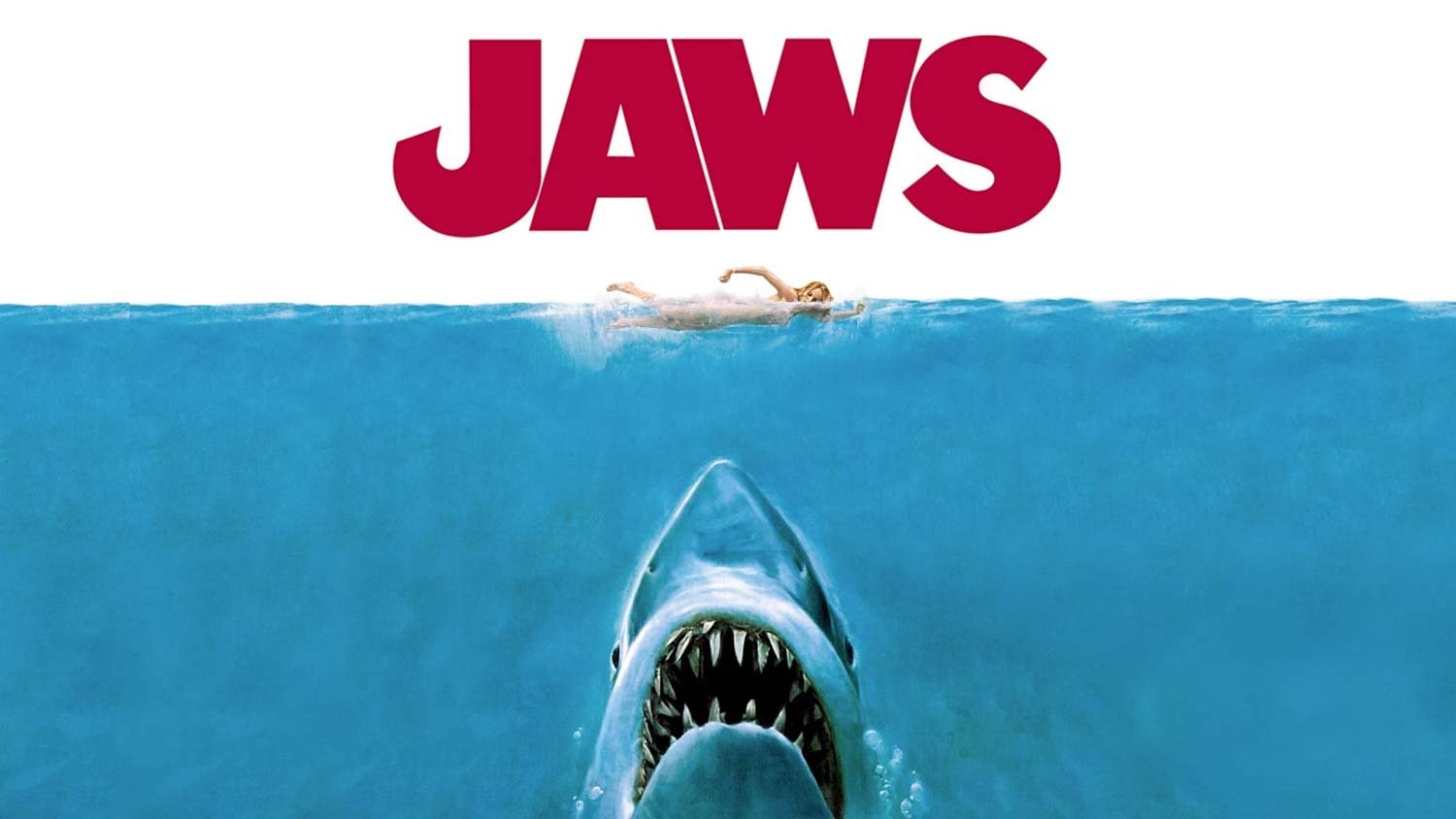 Official theatrical poster for Jaws (1975), showing a swimmer above a giant shark rising from the deep