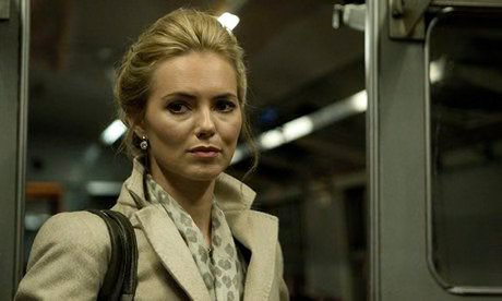 A worried woman standing in a train carriage at night in Last Passenger