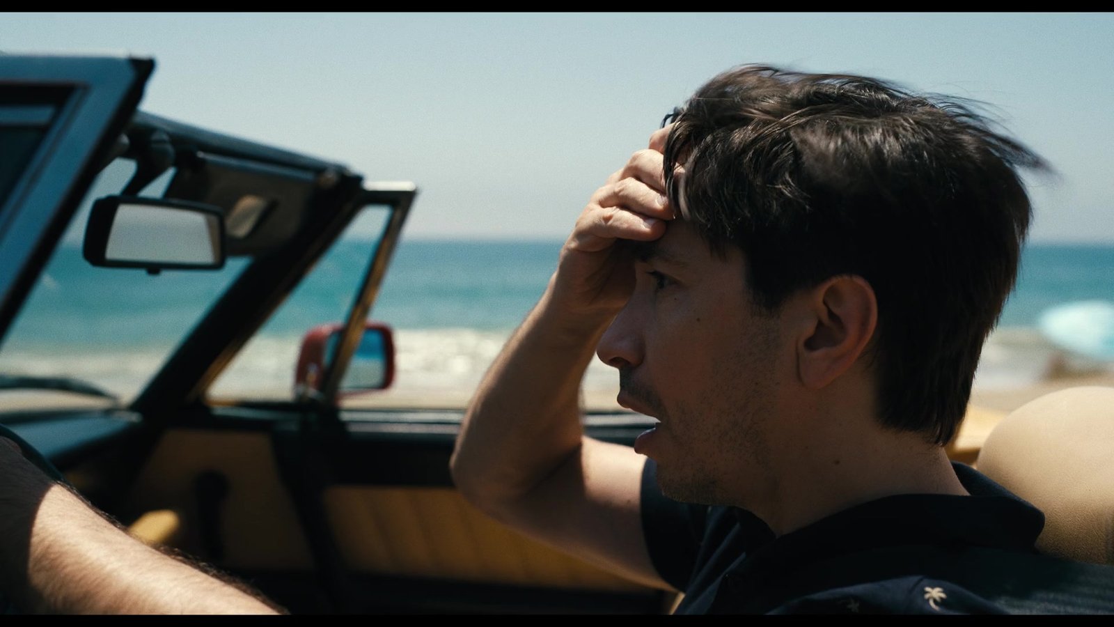 AJ driving along the California coast in a convertible in Barbarian