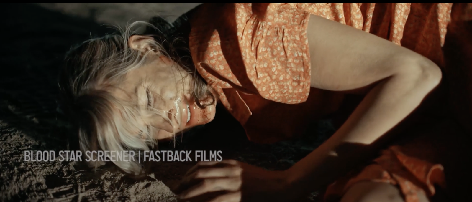 The unnamed woman from Blood Star's cold open, lying face down in the desert, playing dead
