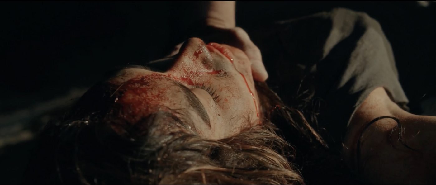 Sheriff Bilstein's hand cradling Bobbi's blood-streaked face, searching for the head wound that isn't there
