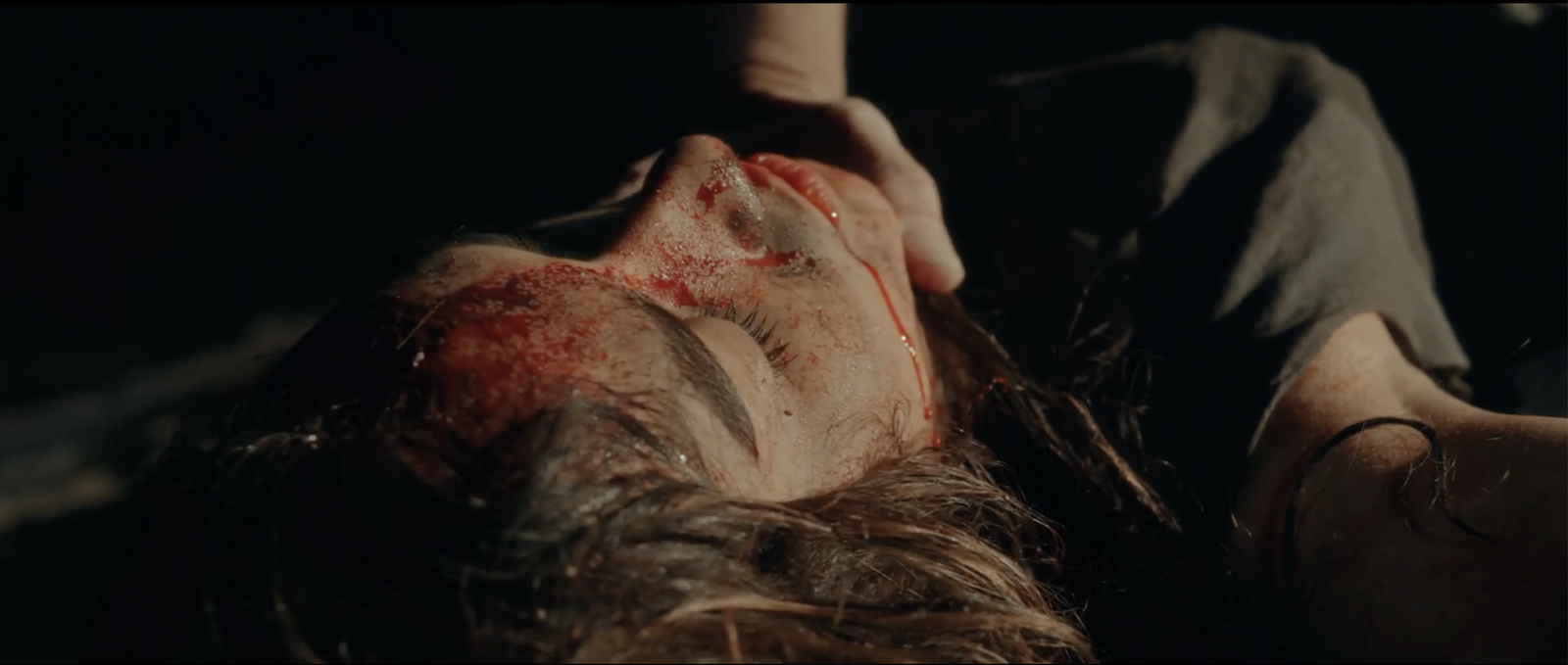 Sheriff Bilstein's hand cradling Bobbi's blood-streaked face, searching for the head wound that isn't there