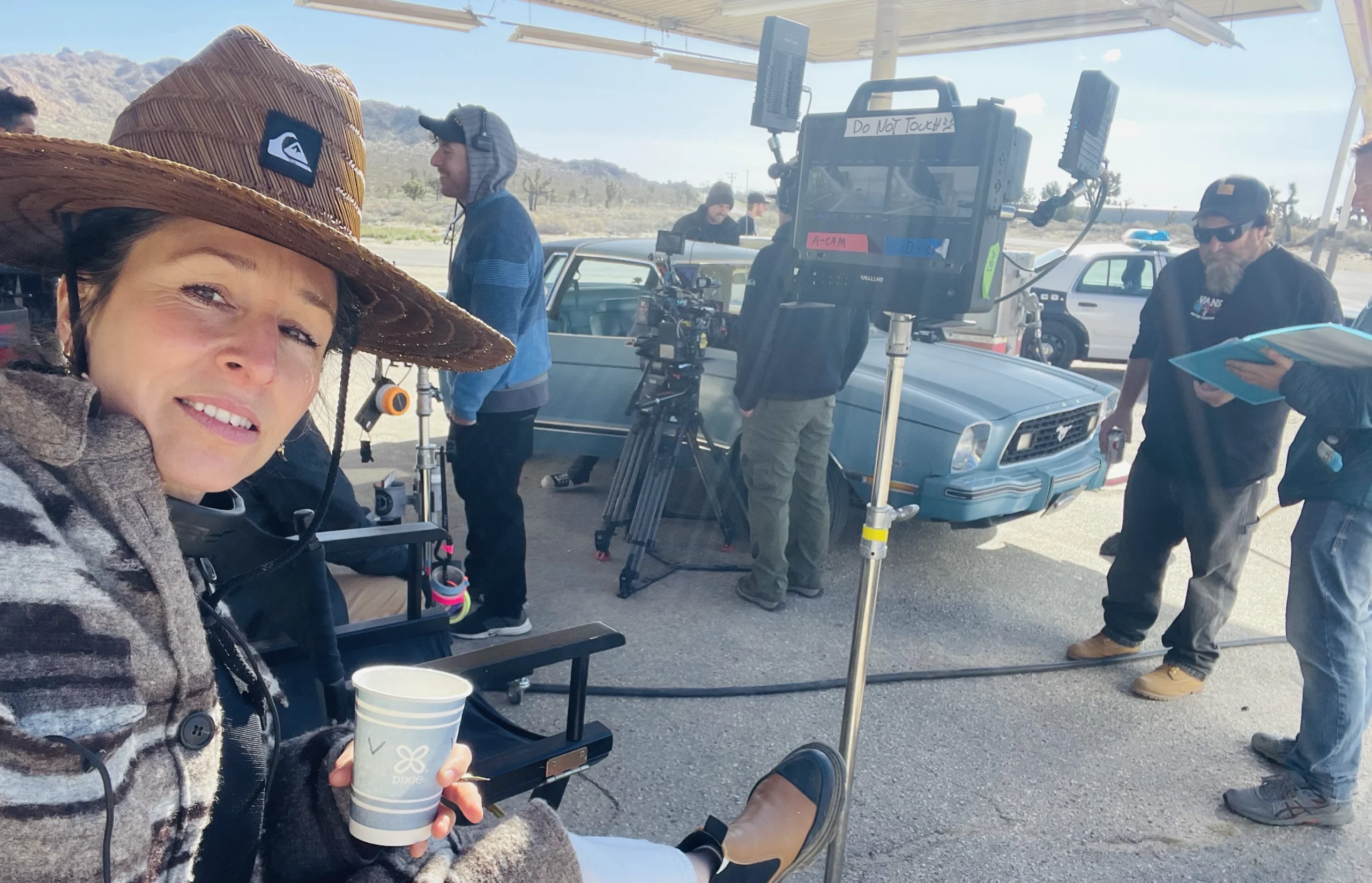 Victoria Taylor on the Blood Star set with a video monitor at a desert gas station location