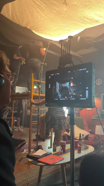 Behind-the-scenes crew rigging lighting on the Obsession set