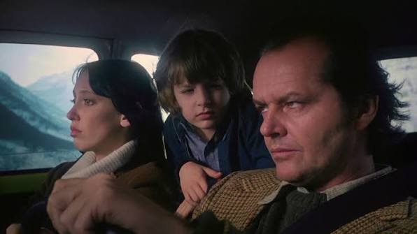 The Torrance family together in the car, driving to the Overlook Hotel