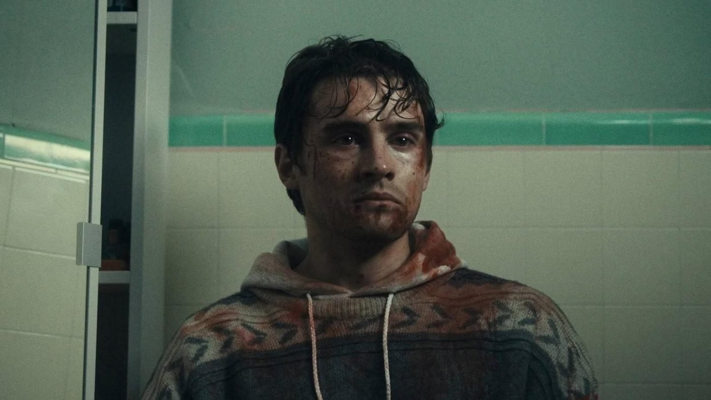 Bear, bloodied and shaken, standing in a bathroom in Obsession (2025)