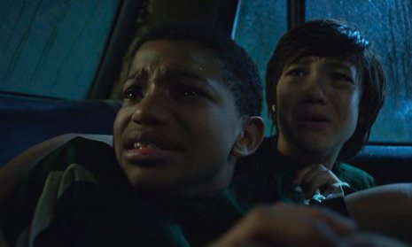 Two frightened boys inside a car at night in The Boy Behind the Door