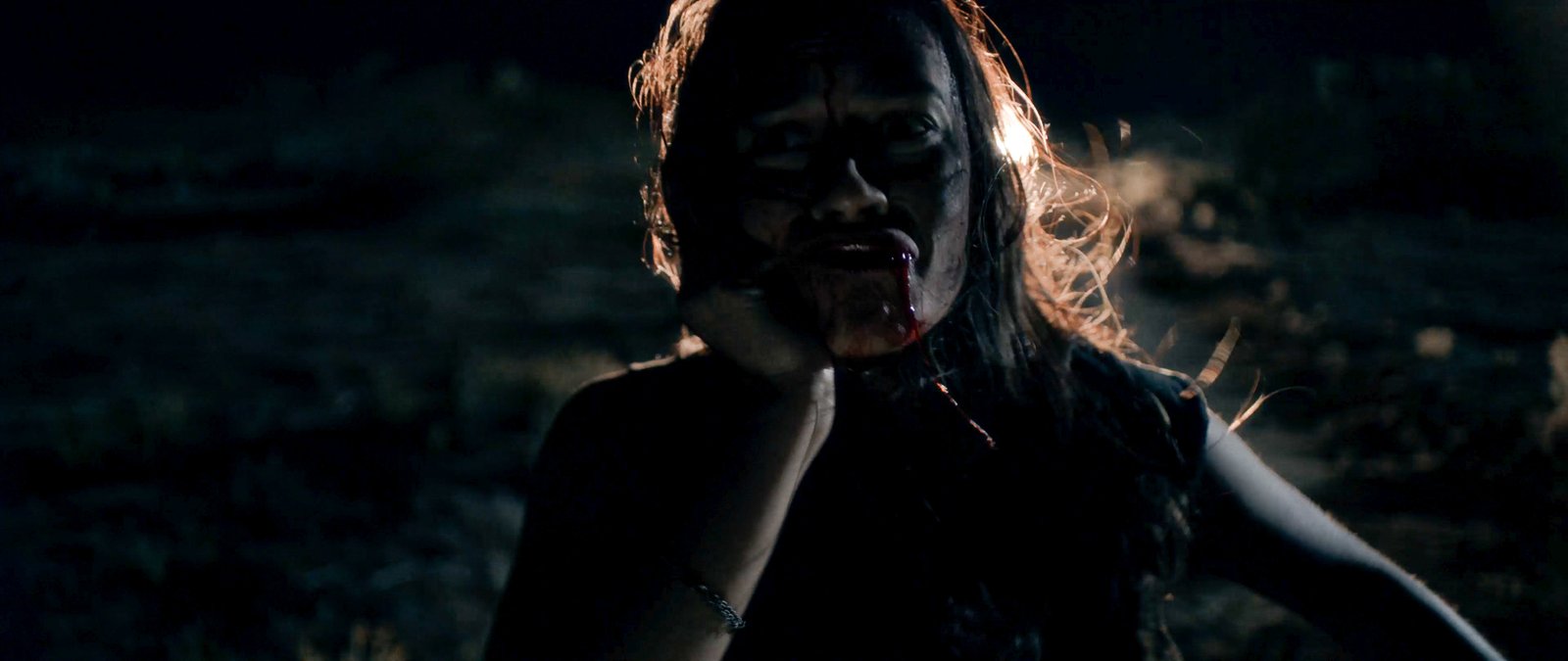Bobbi Torres at night, blood on her face, in Blood Star
