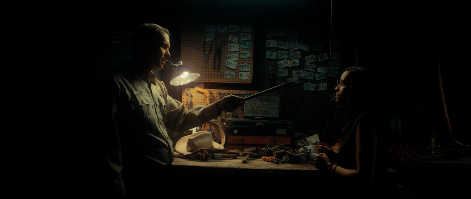 Sheriff Bilstein and Bobbie in a lamp-lit workshop scene from Blood Star