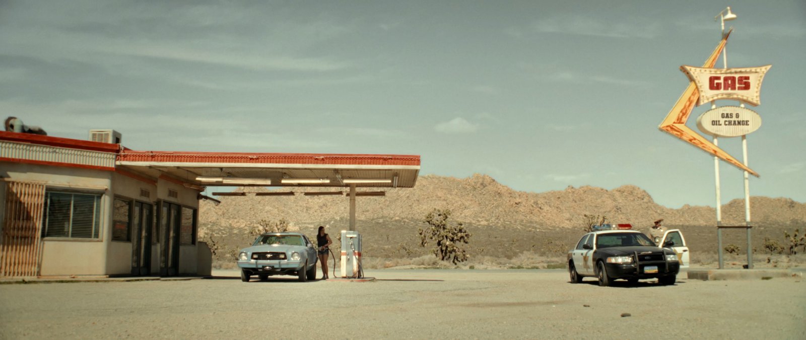 A wide desert cinematography frame from Blood Star, showing an isolated gas station