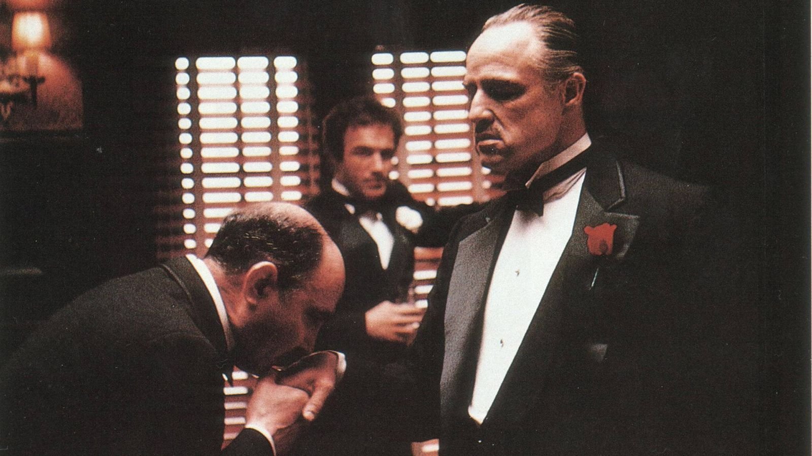 Man kissing Don Corleone’s ring in The Godfather